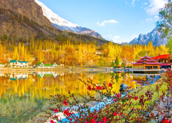 Vibrant autumn view of Shangrila Resort in Skardu, Pakistan, with colorful trees and clear blue skies.