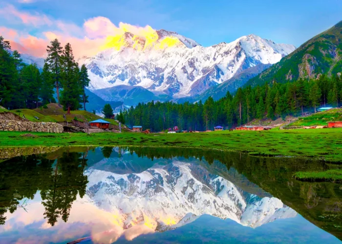 Reflection Pond at Fairy Meadows with Nanga Parbat in the background, Pakistan, showcasing clear water reflecting the towering snow-capped mountain and lush greenery.