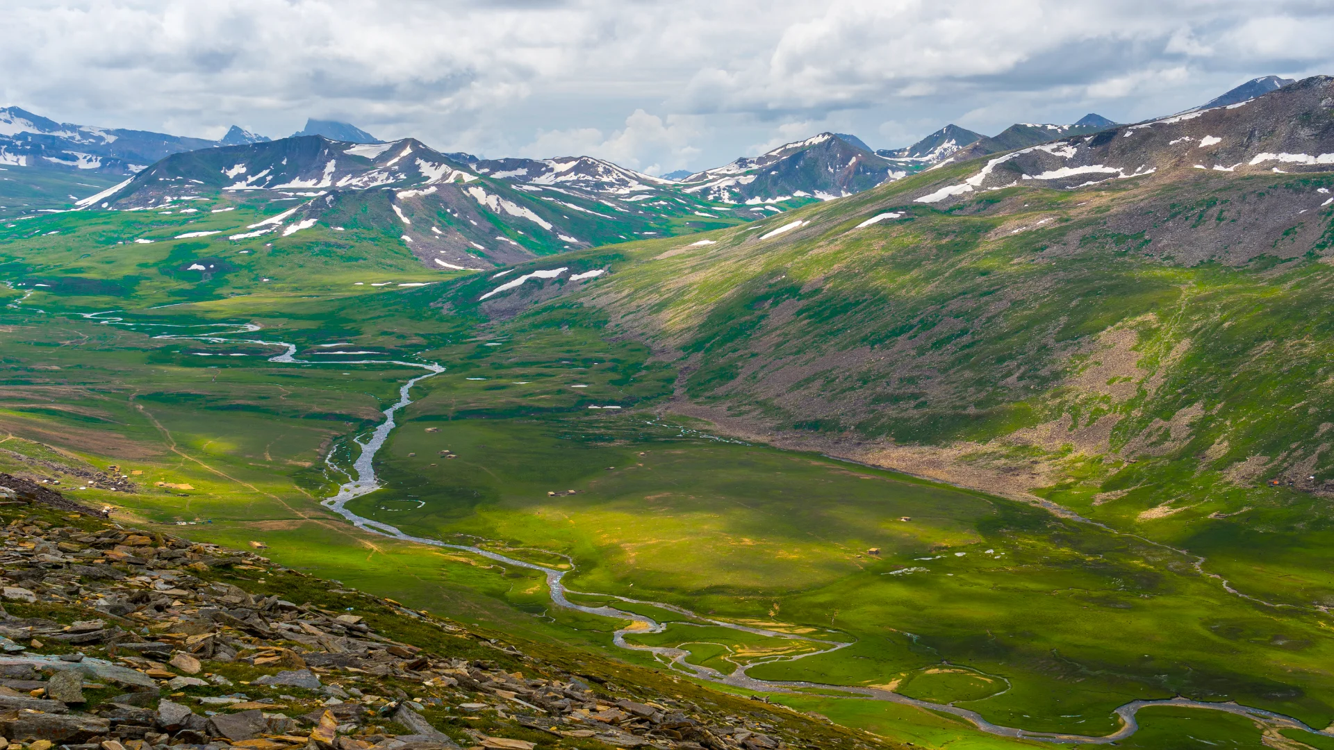 Aerial view of Babusar Pass with lush green mountains in the background.