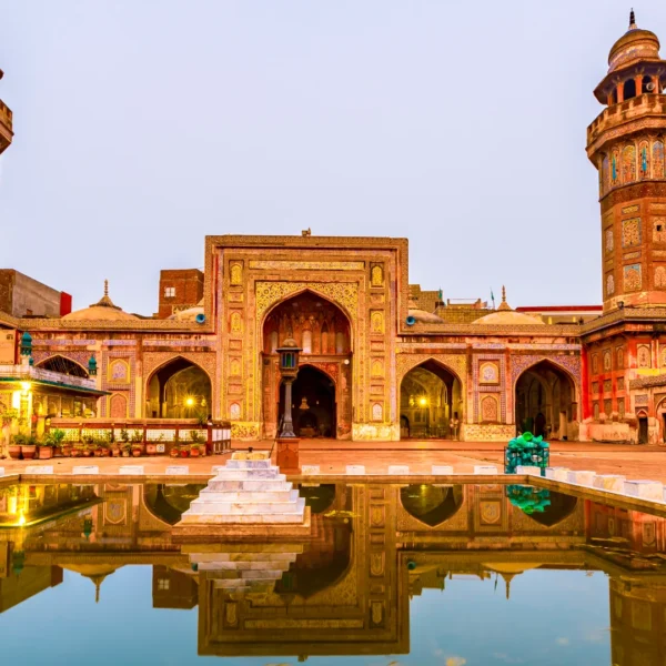 Front view of the Wazir Khan Mosque in Lahore, Pakistan, showcasing its intricate architecture and vibrant colors.