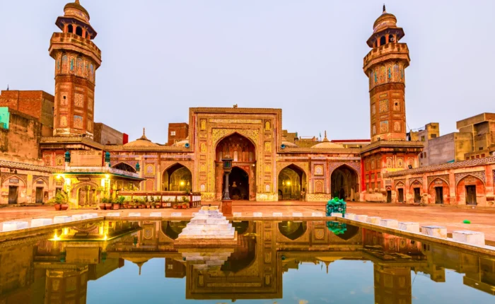 Front view of the Wazir Khan Mosque in Lahore, Pakistan, showcasing its intricate architecture and vibrant colors.