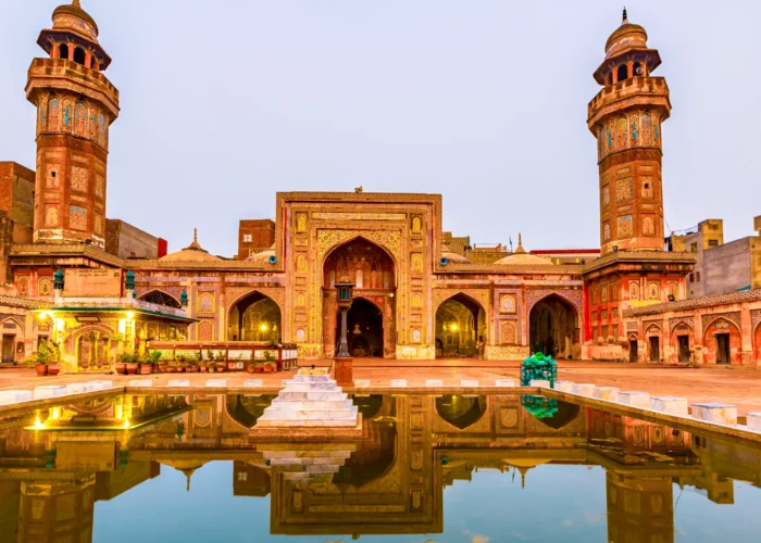 Front view of the Wazir Khan Mosque in Lahore, Pakistan, showcasing its intricate architecture and vibrant colors.