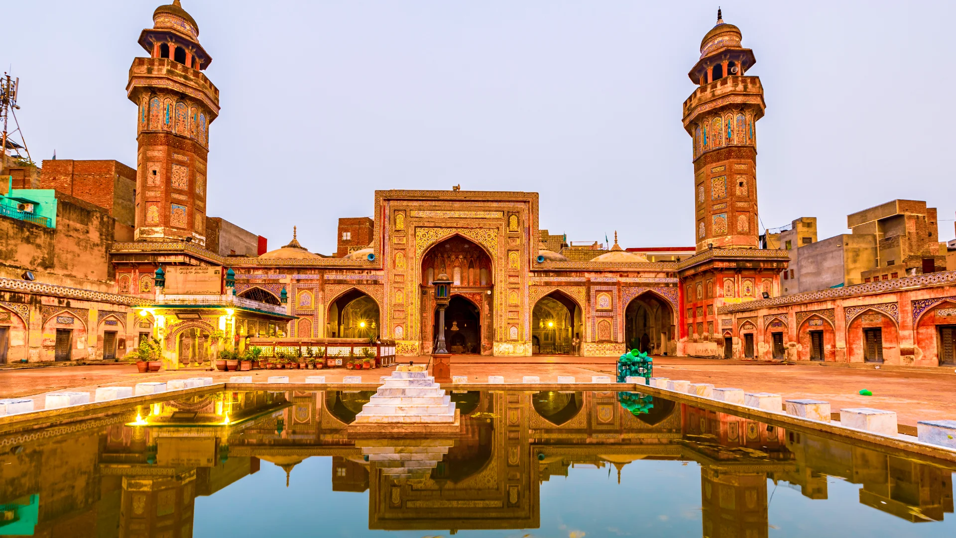 Front view of the Wazir Khan Mosque in Lahore, Pakistan, showcasing its intricate architecture and vibrant colors.